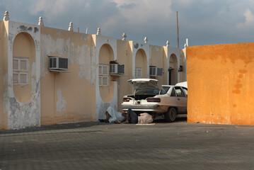 Men repairing car in the street, in Saudi Arabia