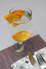 Wine glass with water and orange slice