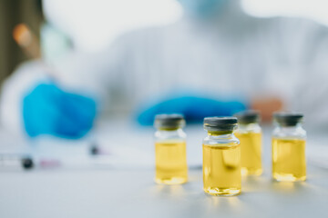 The doctor check and test vaccine in lab and wearing medical gloves, personal protective equipment or ppe, mask, goggle and suit to protect COVID-19 infection. coronavirus, medical, healthcare concept