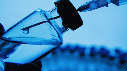 Vaccine bottles and syringe injection. Medicine in ampoules. Glass vials for liquid samples in...