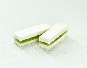 Sweet food apple pastille with marmalade green matcha tea on a white  background