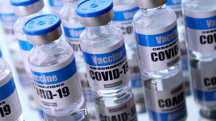 Glass vials for Covid-19 vaccine in laboratory. Group of Coronavirus vaccine bottles. Medicine in ampoules.