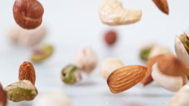 Super slow motion of falling mix nuts.