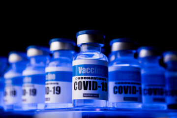 Glass vials for Covid-19 vaccine in laboratory. Group of Coronavirus vaccine bottles. Medicine in ampoules.