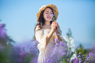 Beautiful asian girl Taking pictures in a flower farm. Happily in Chiang Mai, Thailand