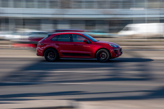 Ukraine, Kyiv - 3 March 2021: Red Porsche Macan car moving on the street;