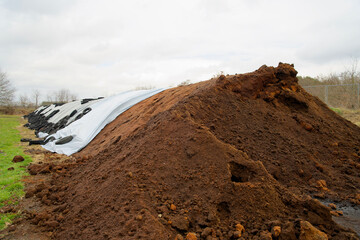 Production plant of organic substrate outdoors. Heap of soil. Fertile substrate, peat free...