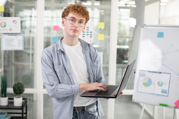 Male IT specialist using laptop for work at office