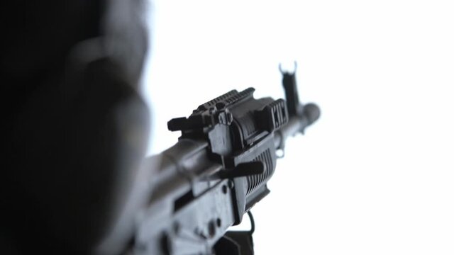 a man holds a Kalashnikov rifle in his hands, switches the safety lock to single fire, raises the weapon up and fires a shot, a misfire on the second shot. winter, close-up, full hd,