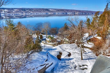 Scenic view on lakeshore of Seneca Lake, New York. Winter landscape on a sunny calm day. 