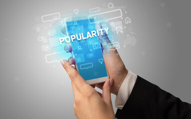 Hand using smartphone with social media concept