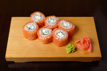 rolls Philadelphia with a salmon an avocado cucumber soft cheese on a board healthy food
