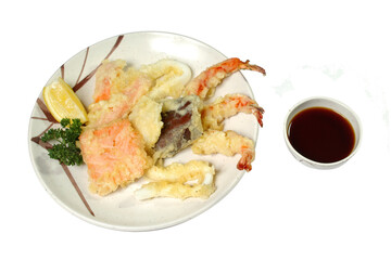 the seafood fried in batter in a plate with sauce it is isolated a white background