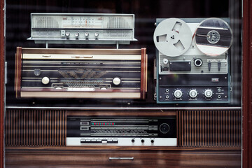 stack of old radio and magnetic tape recorder