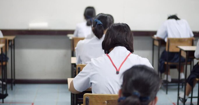 Asian high school students in white school uniform are serious and tired of exams.