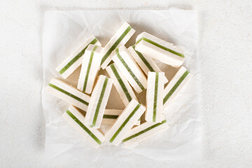 Fruit dessert apple pastille zephyr with marmalade green matcha tea on paper on a light background top view