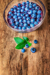 Jelly with blueberry, in a bowl on wooden background. View from above.