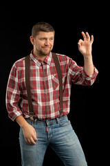 Young stylish man. Studio photo on a black background.