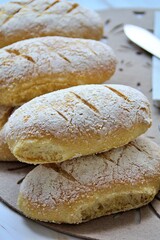 fresh home-made buns with corn flour, small oblong bread sprinkled with flour