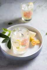 Glass of cool lemonade citrus summer fresh drink with orange, kumquat, lemon and tangerine 