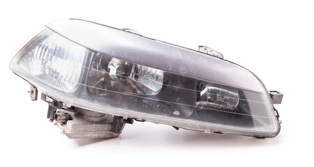 Stylish xenon right headlight of a German car - optical equipment with a lamp inside on a white isolated background. Spare part for auto repair in a car workshop.