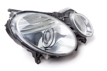 Stylish xenon right headlight of a German car - optical equipment with a lamp inside on a white...