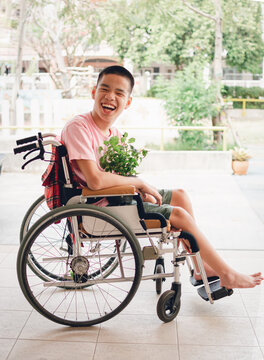 Asian special child on wheelchair and the plants, Development activities and relationships with family time in the house,Lifestyle in education age and happy disabled kid concept.