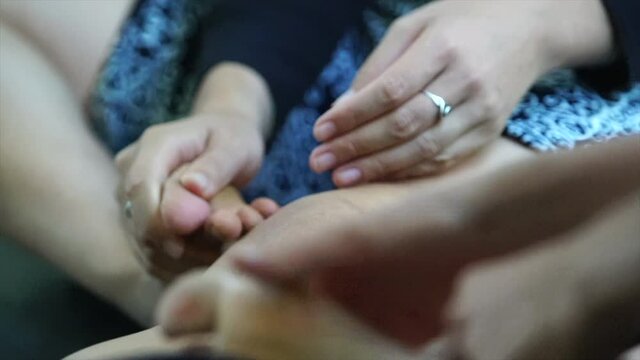 dancers knead their feet facing upward with their hands