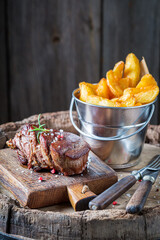 Fresh chips and well done steak. American cuisine.