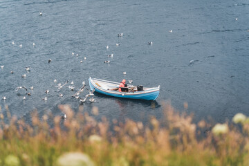 Two traditional boat with fisherman in a natural harbour, Faroe Island