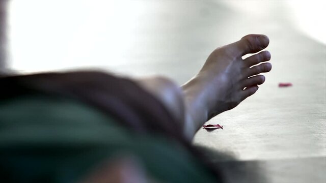 dancers foot lying on the floor on the background of moving figure