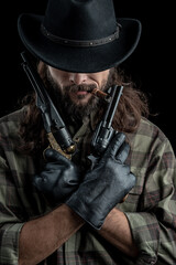 Fototapeta premium Cowboy with guns. Studio shooting