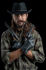 Cowboy with guns. Studio shooting