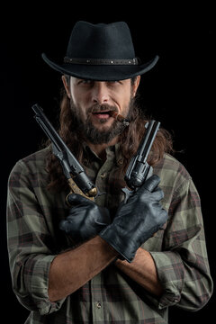 Cowboy with guns. Studio shooting