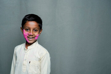 A little boy plays in celebration of Holi