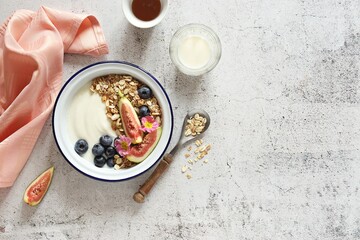 Muesli cereal mix with yogurt, fig and blueberries. Top view, copy space