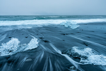 Melted icebergs pushed back onto the black sand beach at Diamond Beach, Iceland.