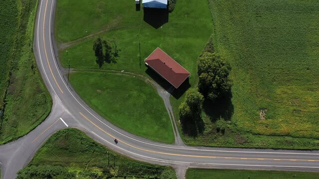 motorcycle riding big bend in rural road overhead aerial