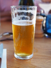 A cold beer glass on a hot summer day