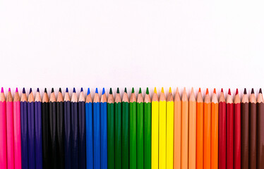 Colored pencils s row on white background.Copy space.