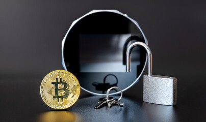 A Bitcoin and a lock in front of a Cryptocurrency Hardware Wallet .