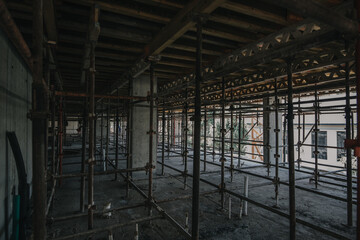 Construction site of multi-storey building with concrete slabs and columns. Men at work .