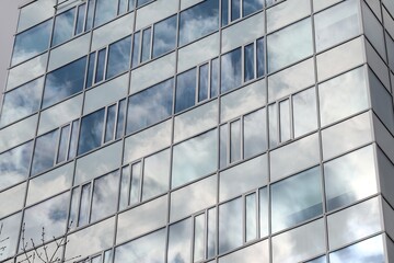 Fototapeta na wymiar Sky and clouds reflection in the windows of the office building at Brno, Czech republic 