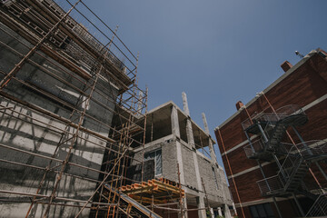 Construction site of multi-storey building with concrete slabs and columns. Men at work .