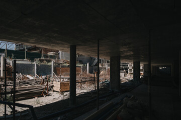 Construction site of multi-storey building with concrete slabs and columns. Men at work .