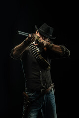 Obraz na płótnie Canvas Cowboy with guns. Studio shooting