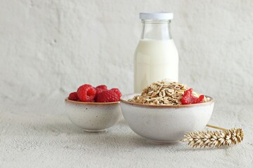 Healthy breakfast with Muesli cereal mix, milk and fresh raspberries .Close up, copy space