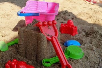 Children's (sand-forming) toy on a sand beach background. Educational Toys