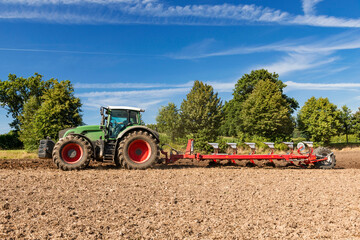 Tractor with 6-share reversible plough is plowing a field 0725