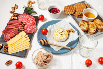Antipasto platter cold meat with bread, salami, slices ham and cheese on wooden background
